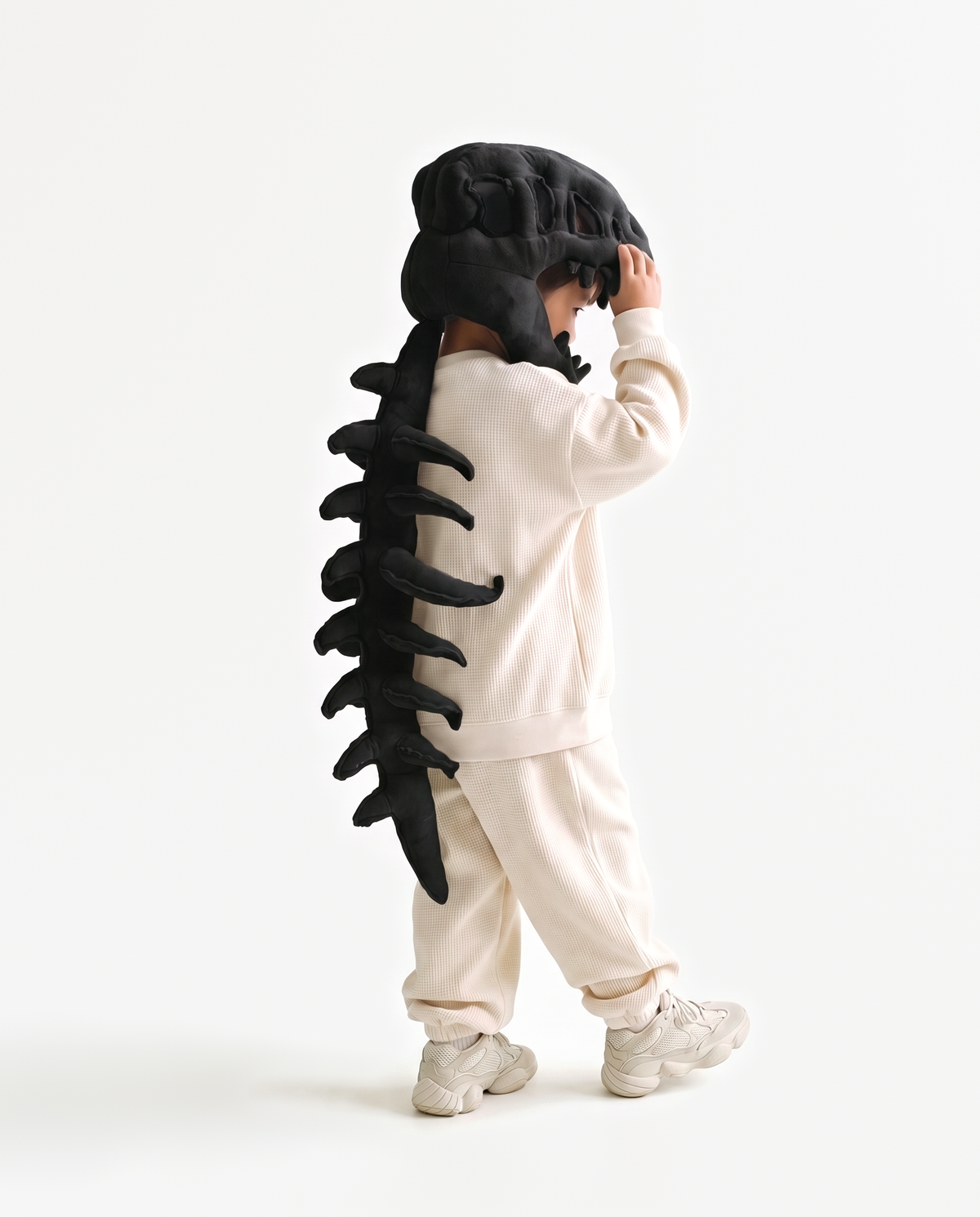 Black Dinosaur Skeleton Costume, side view hand on hood