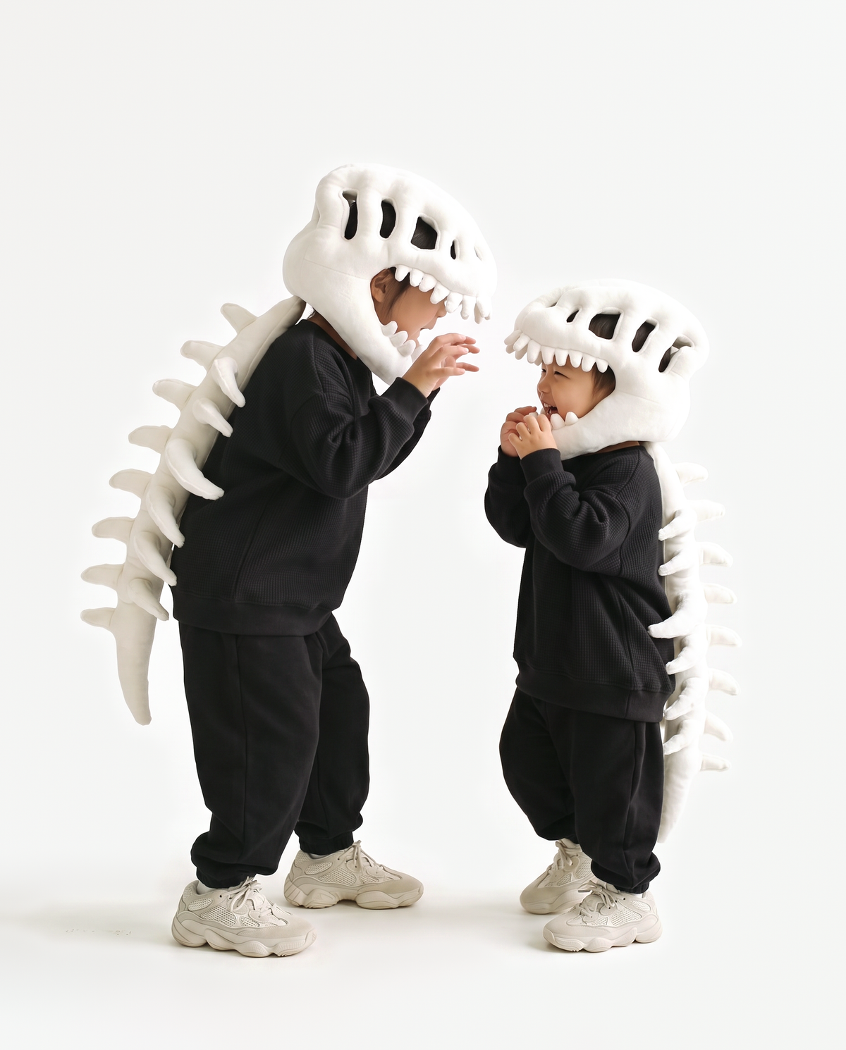 Bone Dinosaur Skeleton Costume, two people in matching costumes face to face