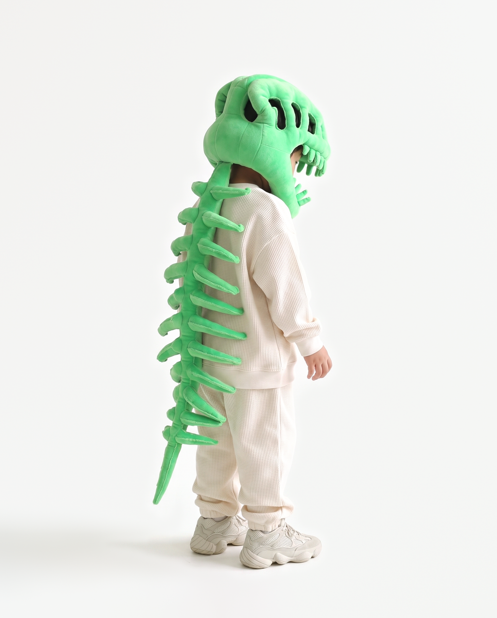 Green Dinosaur Skeleton Costume, side view hand on hood