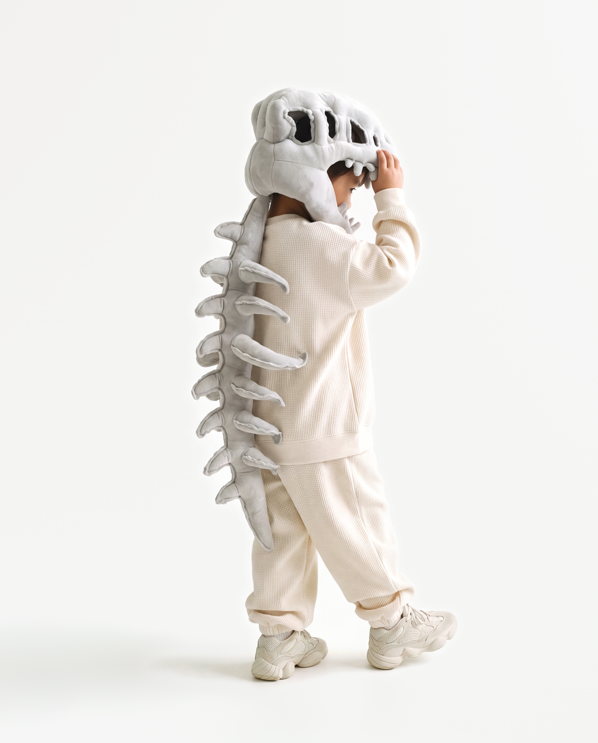 Grey Dinosaur Skeleton Costume, side view hand on hood