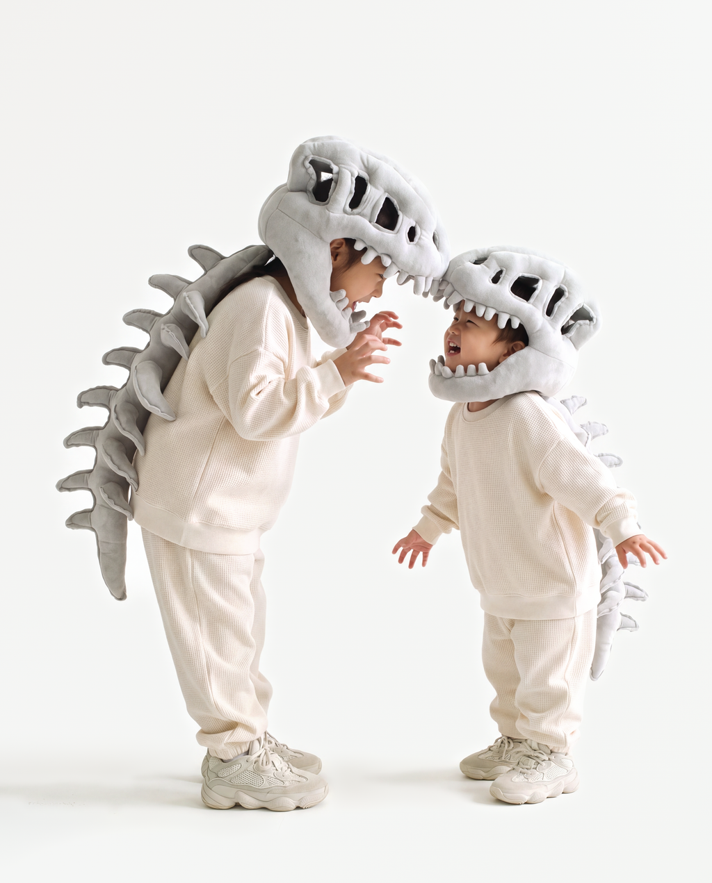 Grey Dinosaur Skeleton Costume, two people in matching costumes face to face